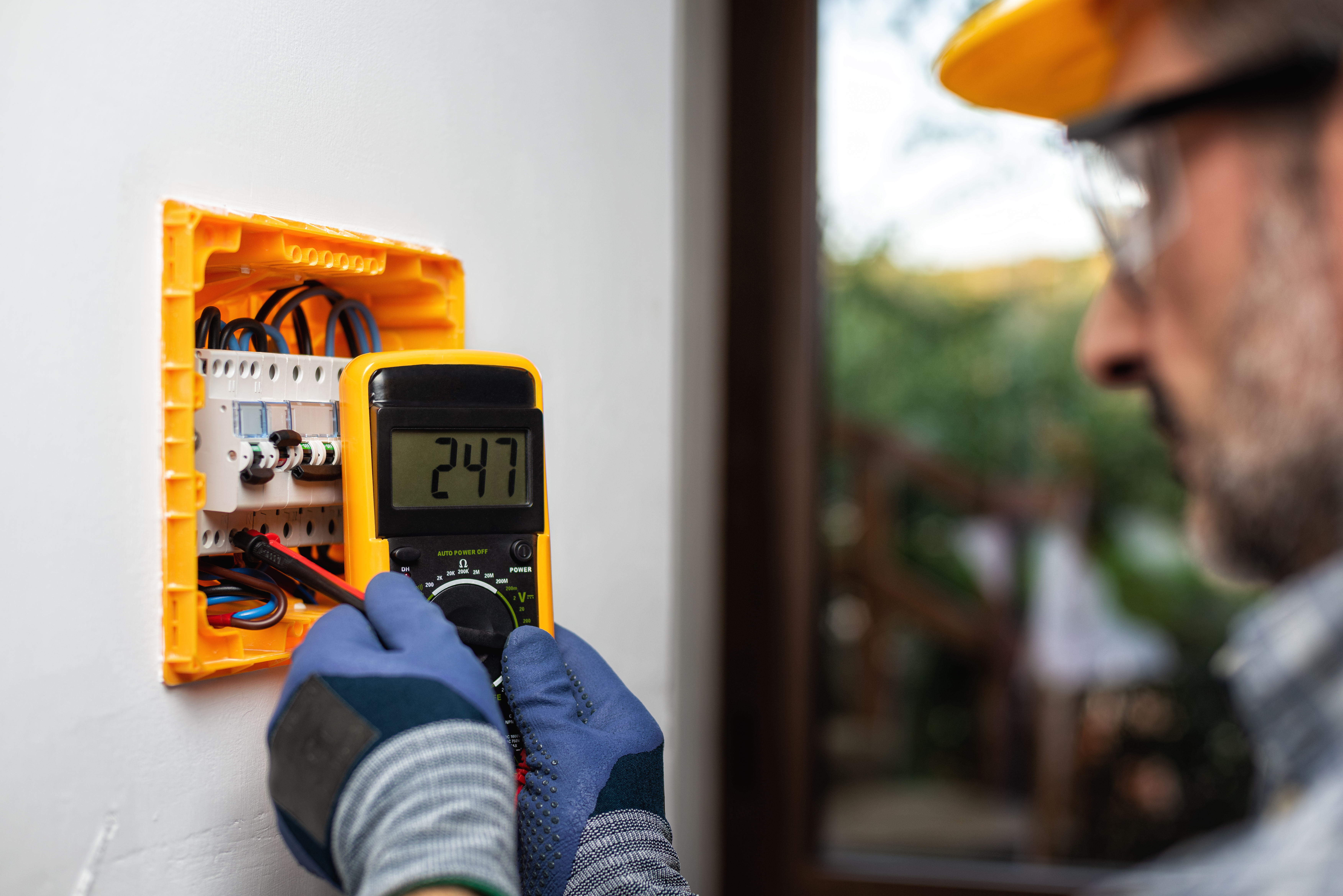 George Brazil electrician repairing an outlet in a Sun City West home
